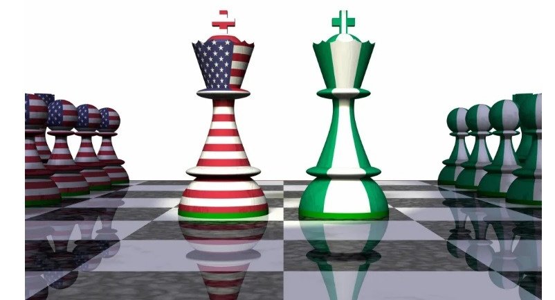 Chess pieces representing two sides working together at the same table