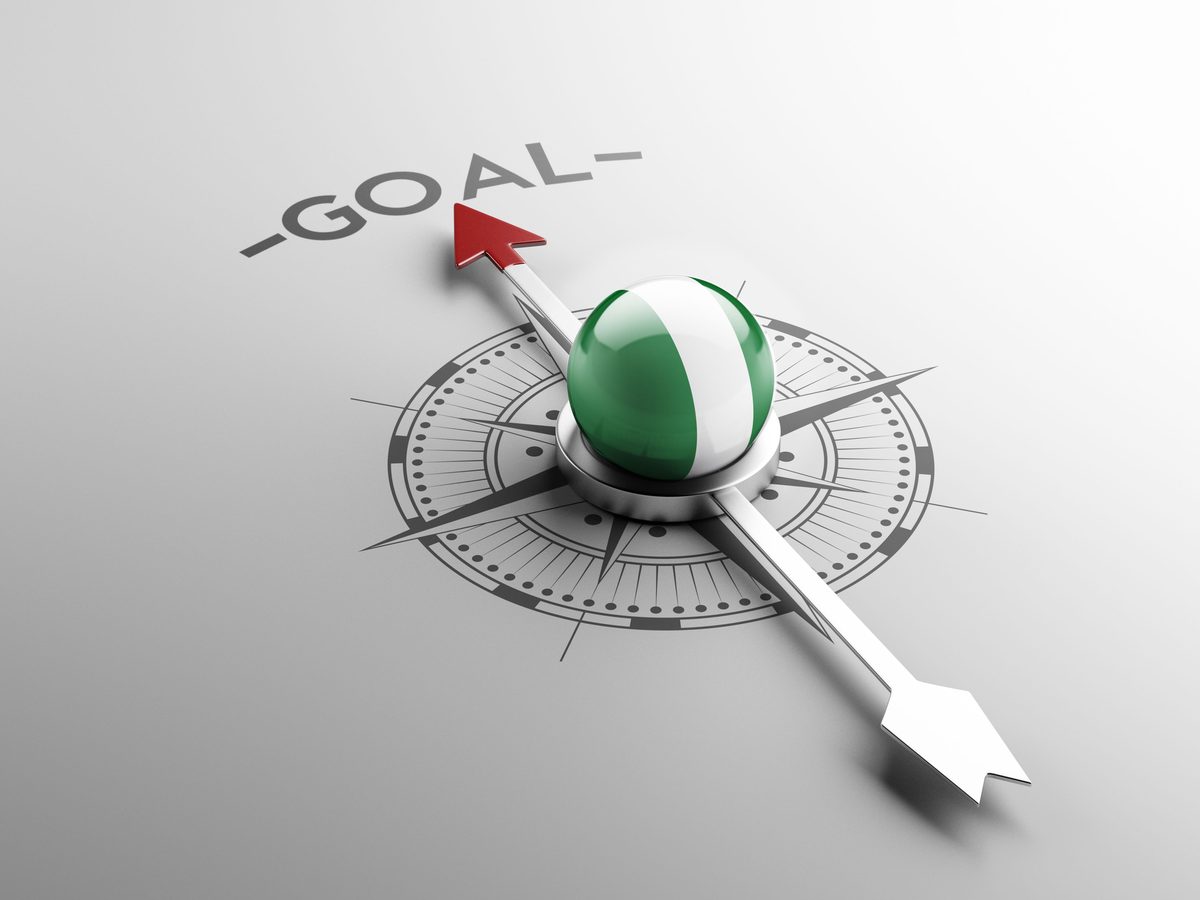 Compass pointing toward a goal, with a Nigerian flag-colored needle